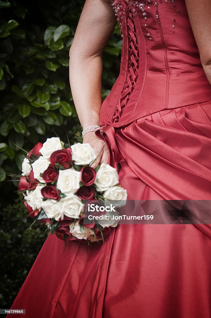 Red Wedding Dress and Bouquet Back of Red Wedding Dress and red and white bouquet Adult Stock Photo