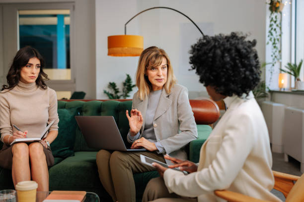 istock Female managers casually working in office lounge. 1467402815
