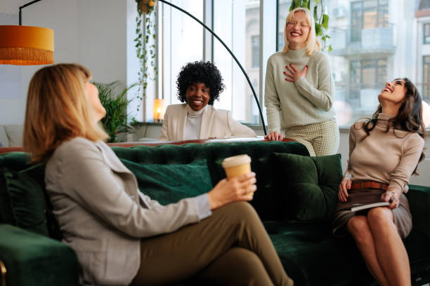 istock Cheerful coworkers relaxing in office lounge. 1467404604