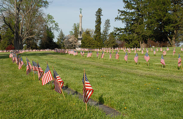 Honoring the hallowed dead Flags adorn the graves of American soldiers killed during the Battle of Gettysburg, fought July 1-3, 1863 between the Union Army of the Potomac and the Confederate Army of Northern Virginia. The soldiers are buried in the National Cemetery at Gettysburg, Pennsylvania. national cemetery stock pictures, royalty-free photos & images