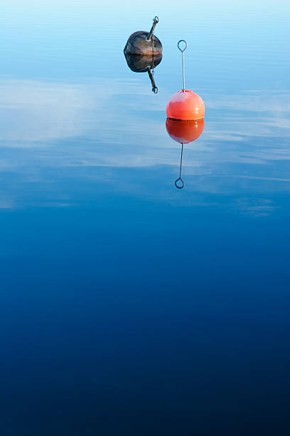 Buoys floating in calm water stock photo