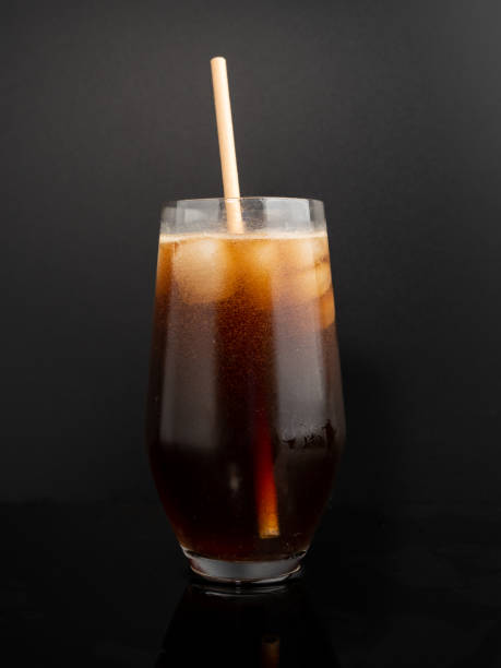istock Glass of cola with ice on a black background. 1467410361