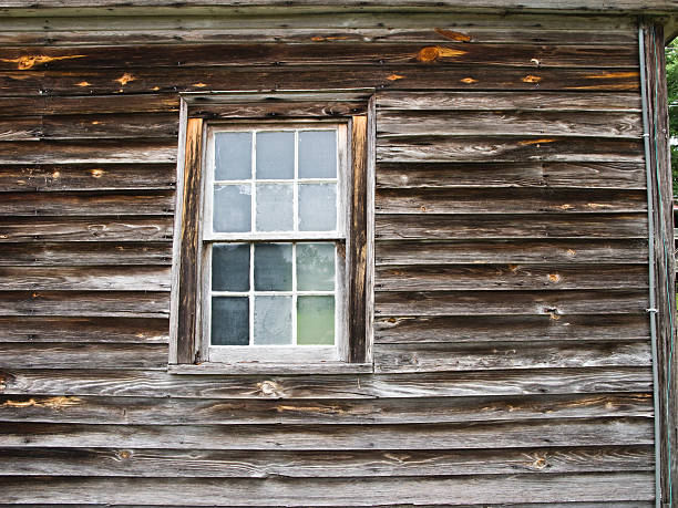 istock Side of weatherd home with window 146741053