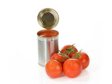 Can of peeled tomatoes on bright background