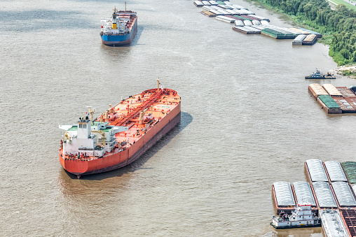 Two different cargo ships sailing along the Mississippi River near New Orleans shot from an altitude of about 500 feet.