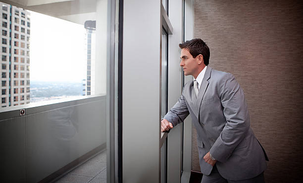 istock Businessman looking out of window 146742354