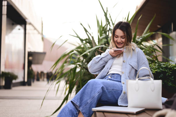 istock student with computer resting outdoors on the bench and taking photos. 1467423636