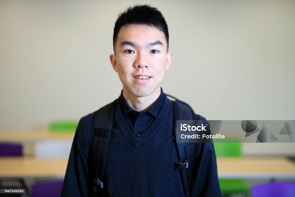 Portrait Of Young Male University Student In A Classroom Stock Photo portrait-of-young-male-university-student-in-a-classroom-stock-photo
