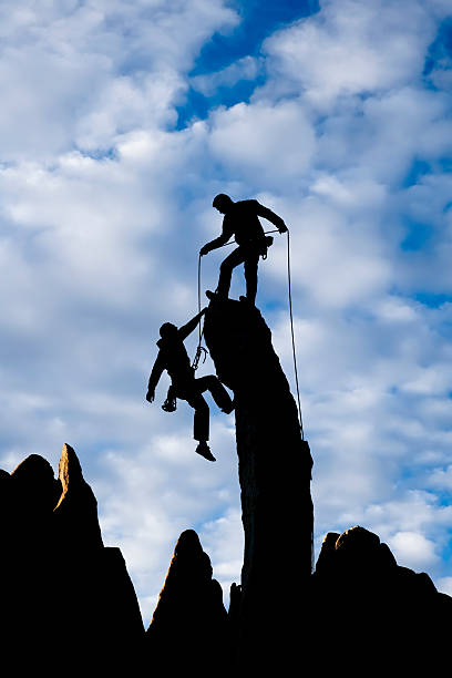istock Team of climbers reaching the summit. 146742925