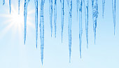 Icicles on a blue sky background