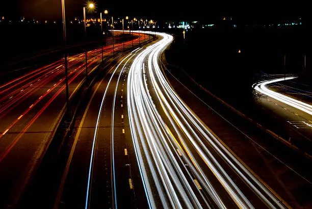 Shot of a motorway from a bridge. Taken in Birmingham of the M5 near the junction of the A456. Darkened slightly and colour boosted to create a slightly retro feel.