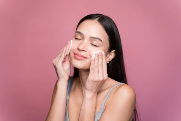 istock Young woman wiping makeup with absorbent cotton 1467434463