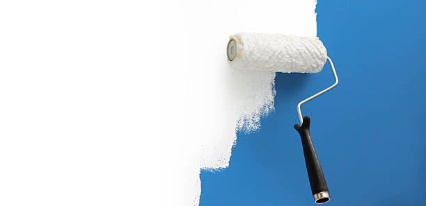 istock Roll of white paint going over previous blue paint 146743464