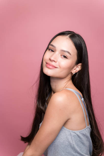 istock Smiling woman looking at camera on pink background 1467435152
