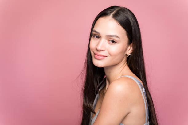 istock Smiling woman looking at camera on pink background 1467435757