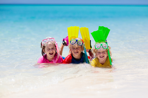 Kids snorkel. Beach fun. Children snorkeling in tropical sea on family summer vacation on exotic island. Child with mask and fins. Travel with kid. Little boy and girl learning to dive. Diving holiday