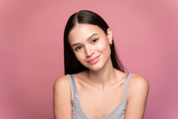 istock Young woman with makeup against pink background 1467436583