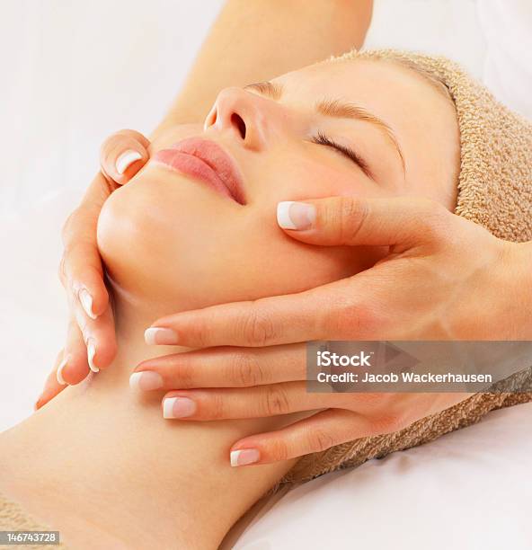 Beautiful Young Woman Getting Facial Massage At Spa Stock Photo - Download Image Now