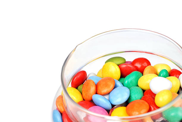 Assorted colorful chocolate candies. Chocolate pattern on pink background.
