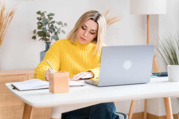 istock Focused woman working on laptop 1467443457