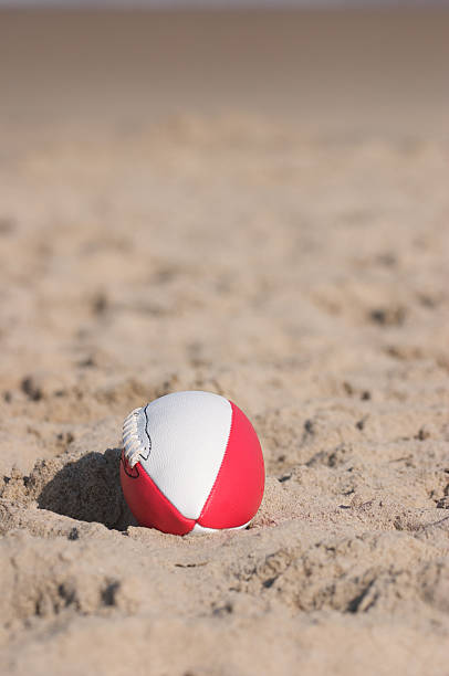 istock Red Football on Beach 146744357