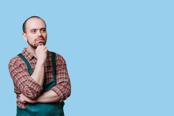 istock Concentrating, pensive workman in studio, Serious, meditative man in portrait 1467445123