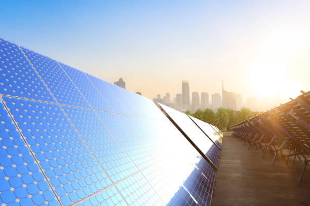 istock Solar panel farm on green field with cityscape background 1467445169