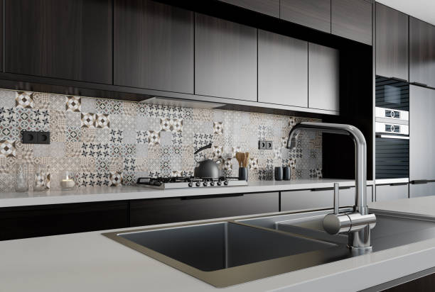 Modern minimalist kitchen with long island. Backsplash in focus. stock photo