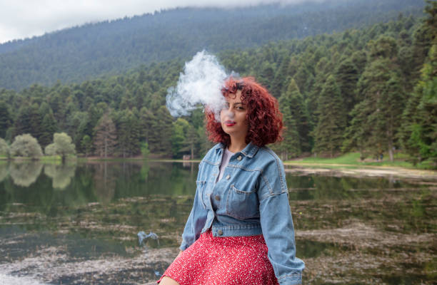istock A woman smoking in nature 1467451934