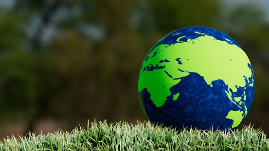globe located on the ground with grass, showing europe, asia, africa and australia, 3d illustration