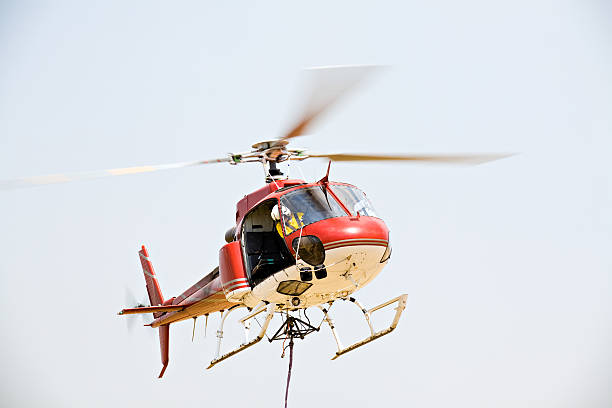 helicopter picking up cargo stock photo