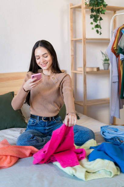 istock Smiling woman checking their new clothes at bed 1467458602