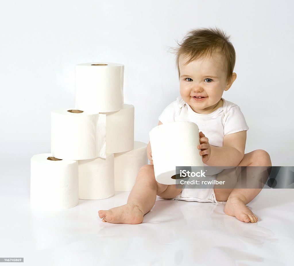 Baby with toilet paper Curious baby girl playing with rolls of toilet paper. Baby - Human Age Stock Photo