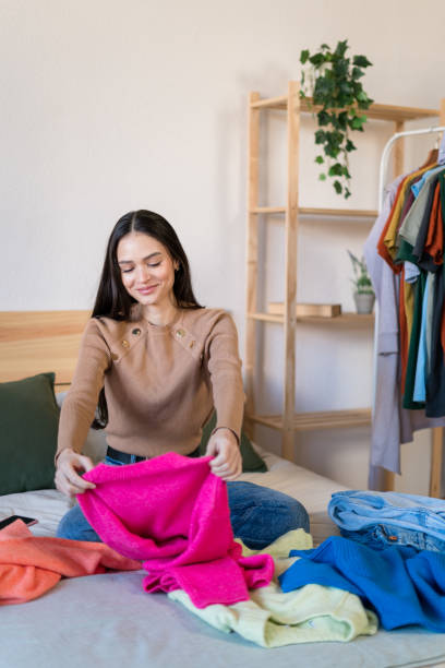 istock Smiling woman checking their new clothes at bed 1467458699