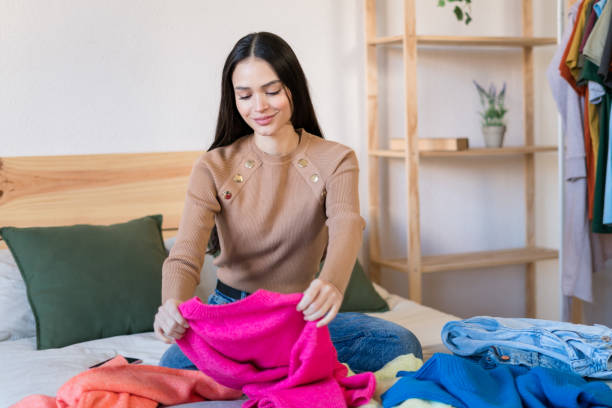 istock Smiling woman checking their new clothes at bed 1467458744