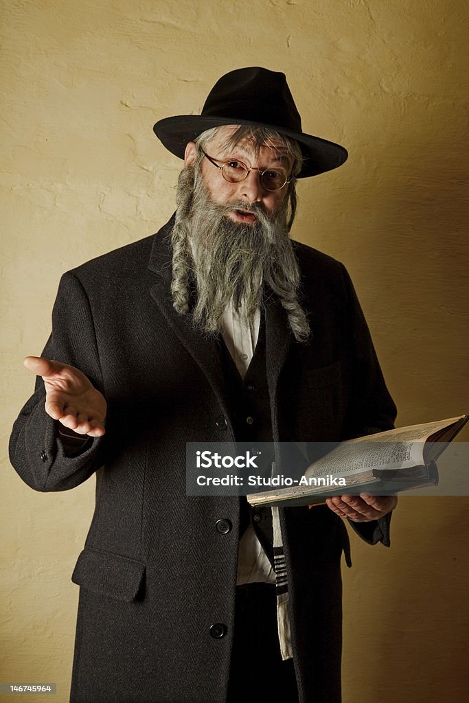 Old jew with book Old jewish man with grey beard holding a book Rabbi Stock Photo