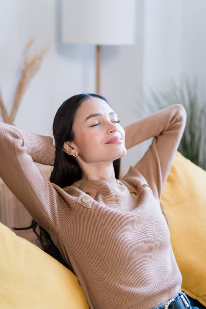 istock Young woman lying on sofa relaxing 1467462279