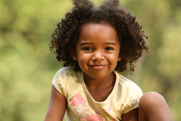 Portrait of a Young African American girl posing outside stock photo