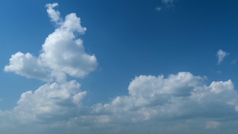 Cloud sky scape. Clouds flying and changing with different shapes on clear blue sky. Timelapse.