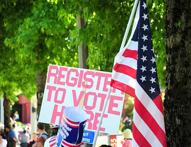 Register to vote Register to vote sign at a peace rally. voter registration stock pictures, royalty-free photos & images