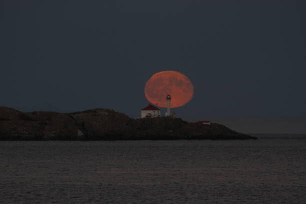 istock Full moon rising behind Trial Islands Lighthouse in Victoria, Canada 1467464934