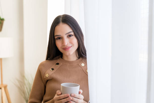 istock Smiling woman with cup of coffee 1467468094