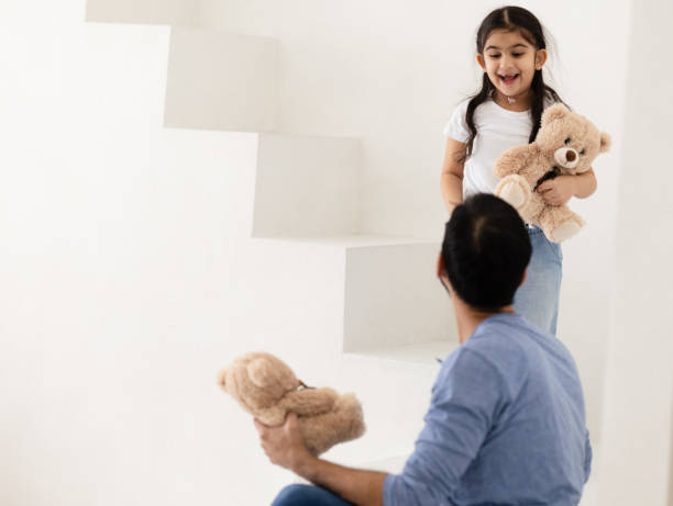 istock Father and Daughter Playing With Teddybears 1467468920