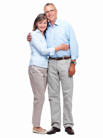 Happy senior couple standing together against white background