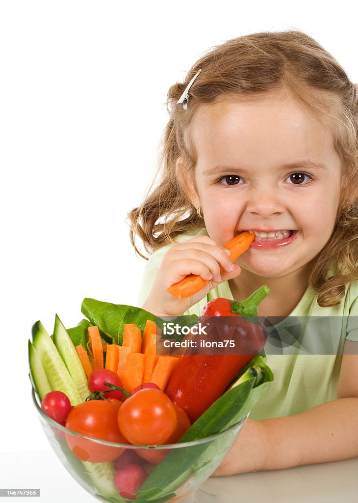Happy carrot chomping girl Happy healthy little girl eating vegetables - chomping a carrot - isolated Beautiful People Stock Photo
