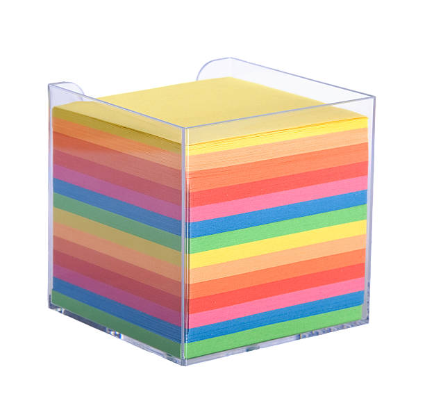 Stack of multicolored notes  in a plastic box stock photo