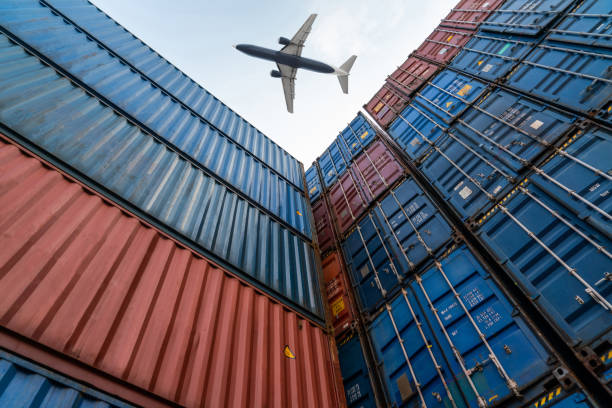istock Freight airplane flying above overseas shipping container . Logistics supply chain management and international goods export concept . 1467476688