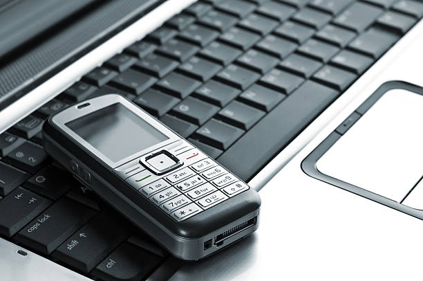 istock mobile phone over laptop keyboard 146747860