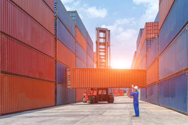 istock Engineers are overseeing the transportation of cargo with containers inside the warehouse. Container in export and import business and logistics. 1467479230