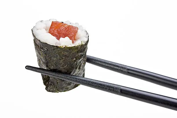 tunafish sushi held by chopsticks isolated on white